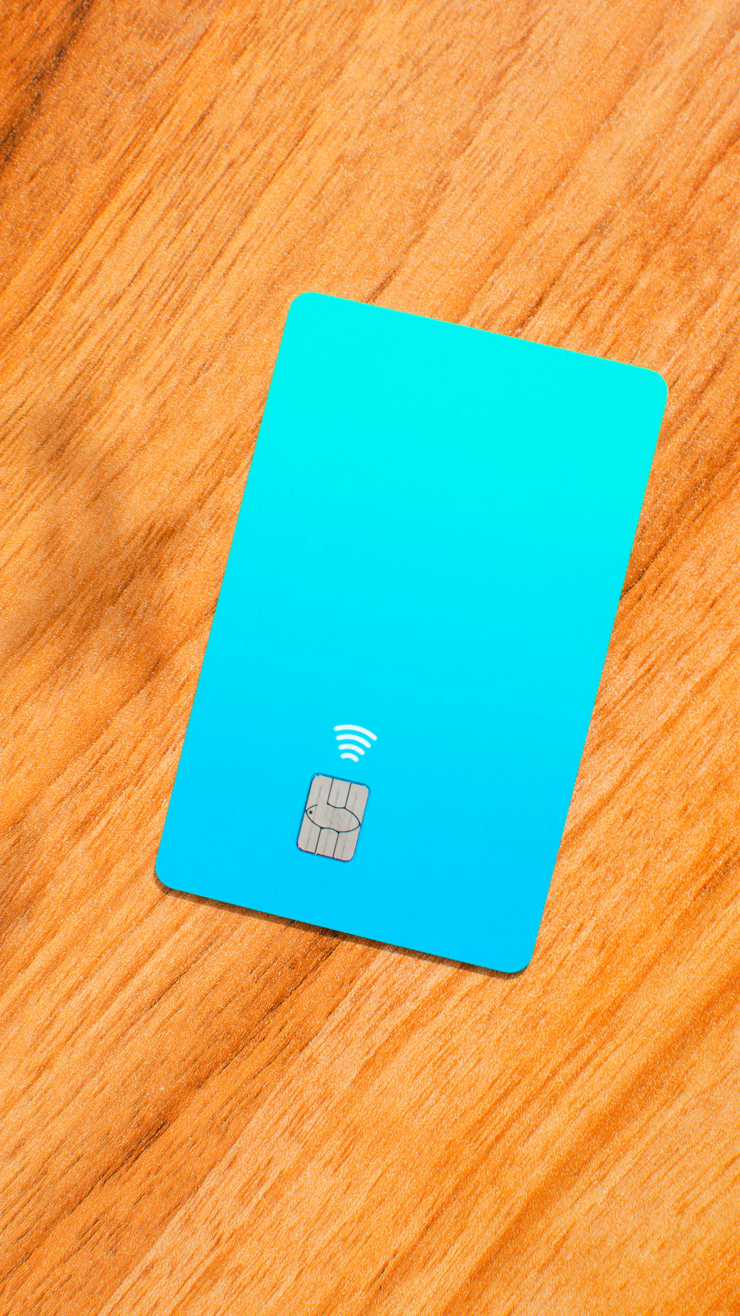 a blue sim card sitting on top of a wooden table