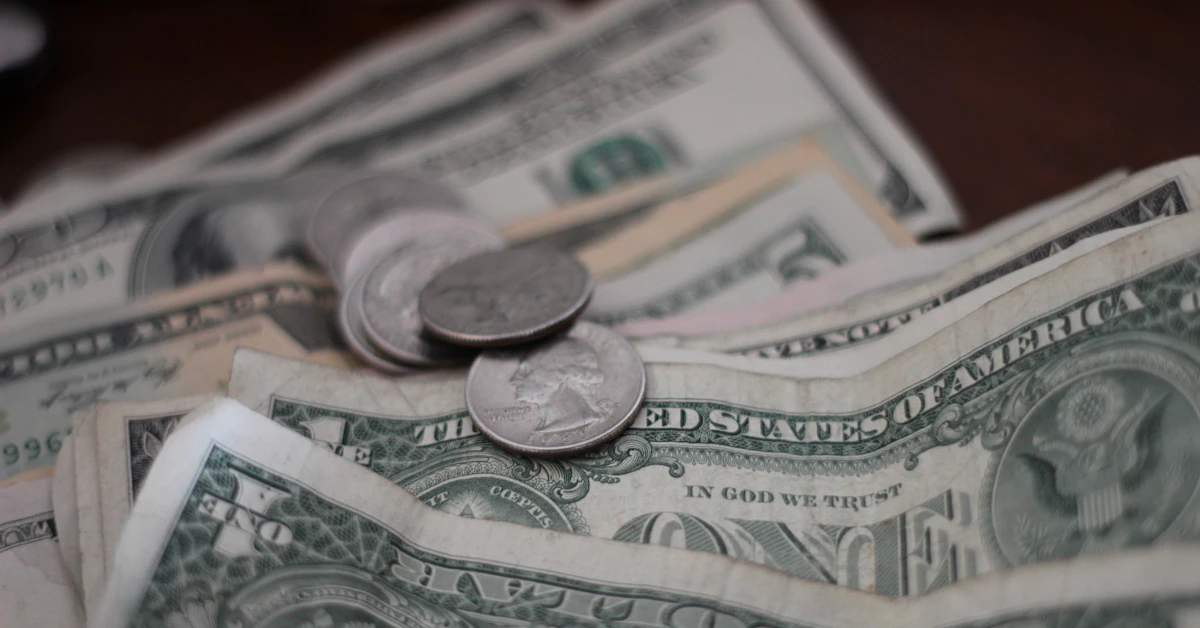 photo of dollar coins and banknotes