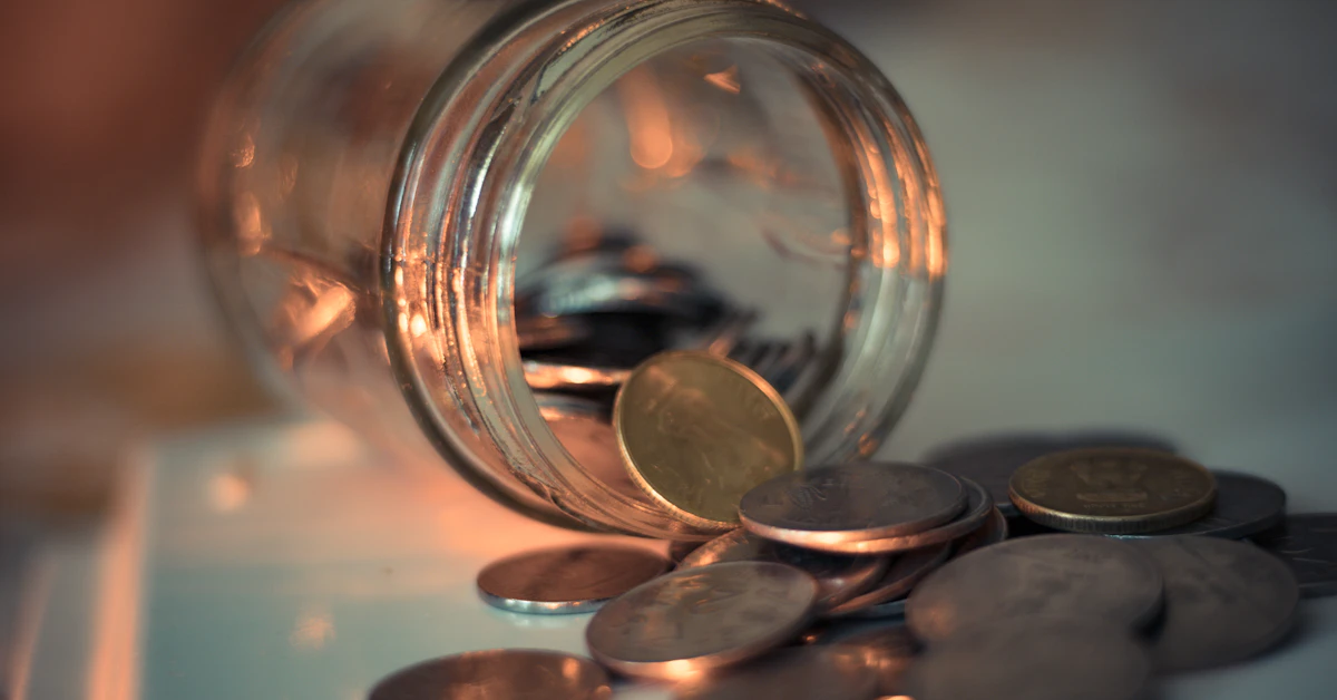 clear glass jar with coins