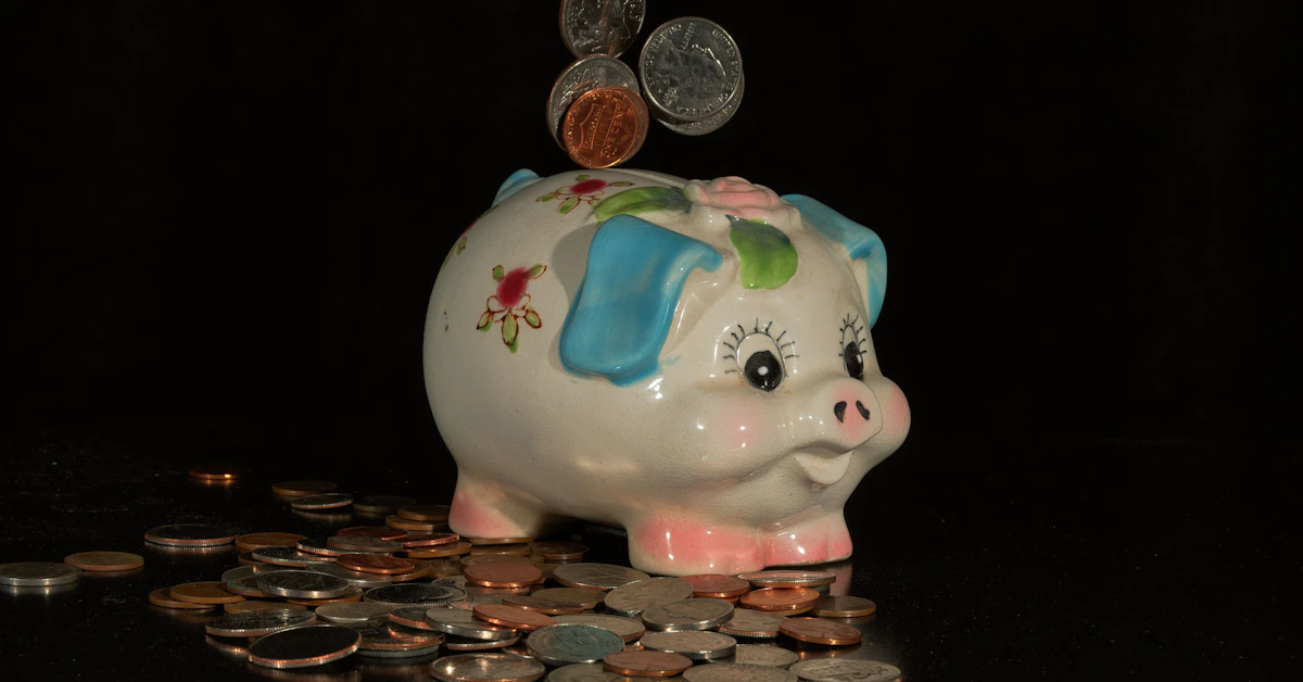 Coins falling into a piggy bank on a black background