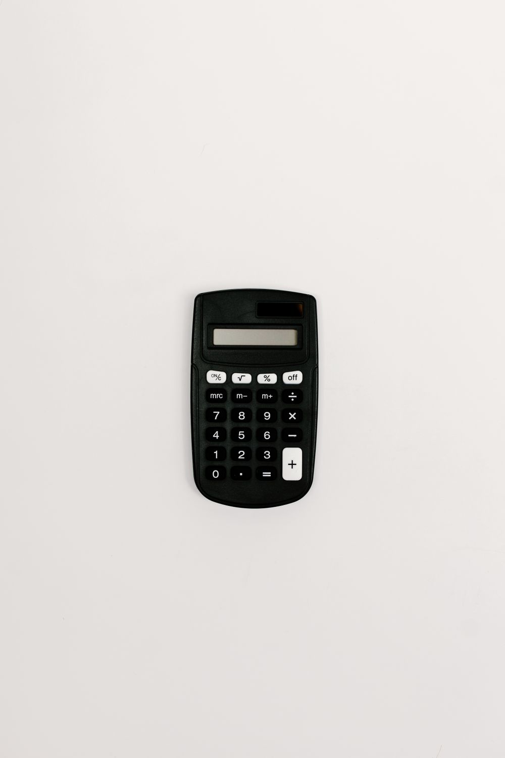 A black calculator placed on a white background, ideal for financial and accounting themes.