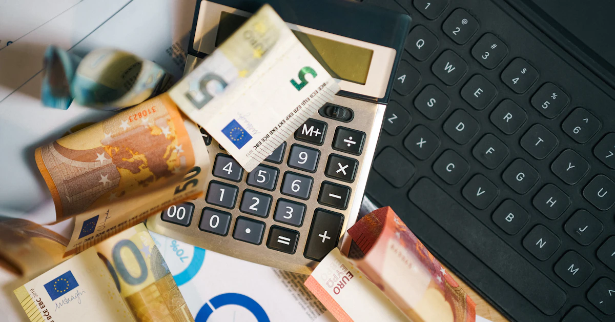 A calculator sitting on top of a pile of money