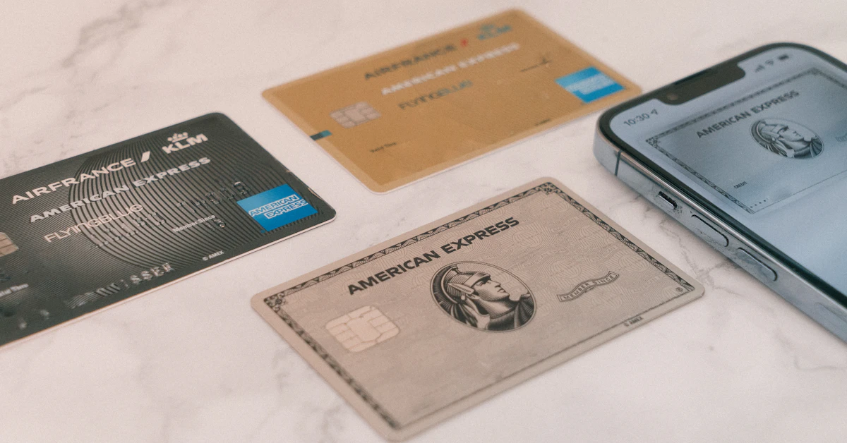 a group of credit cards sitting next to a cell phone