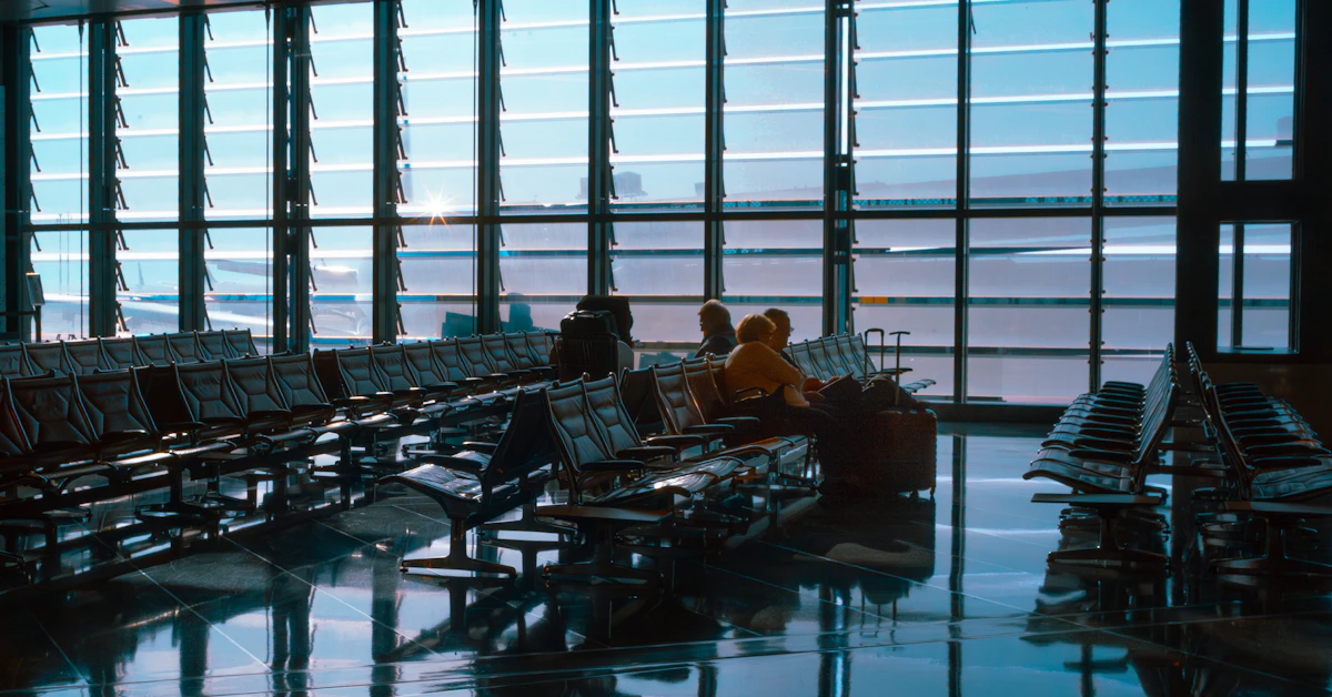 An airport waiting area with large windows and reflections